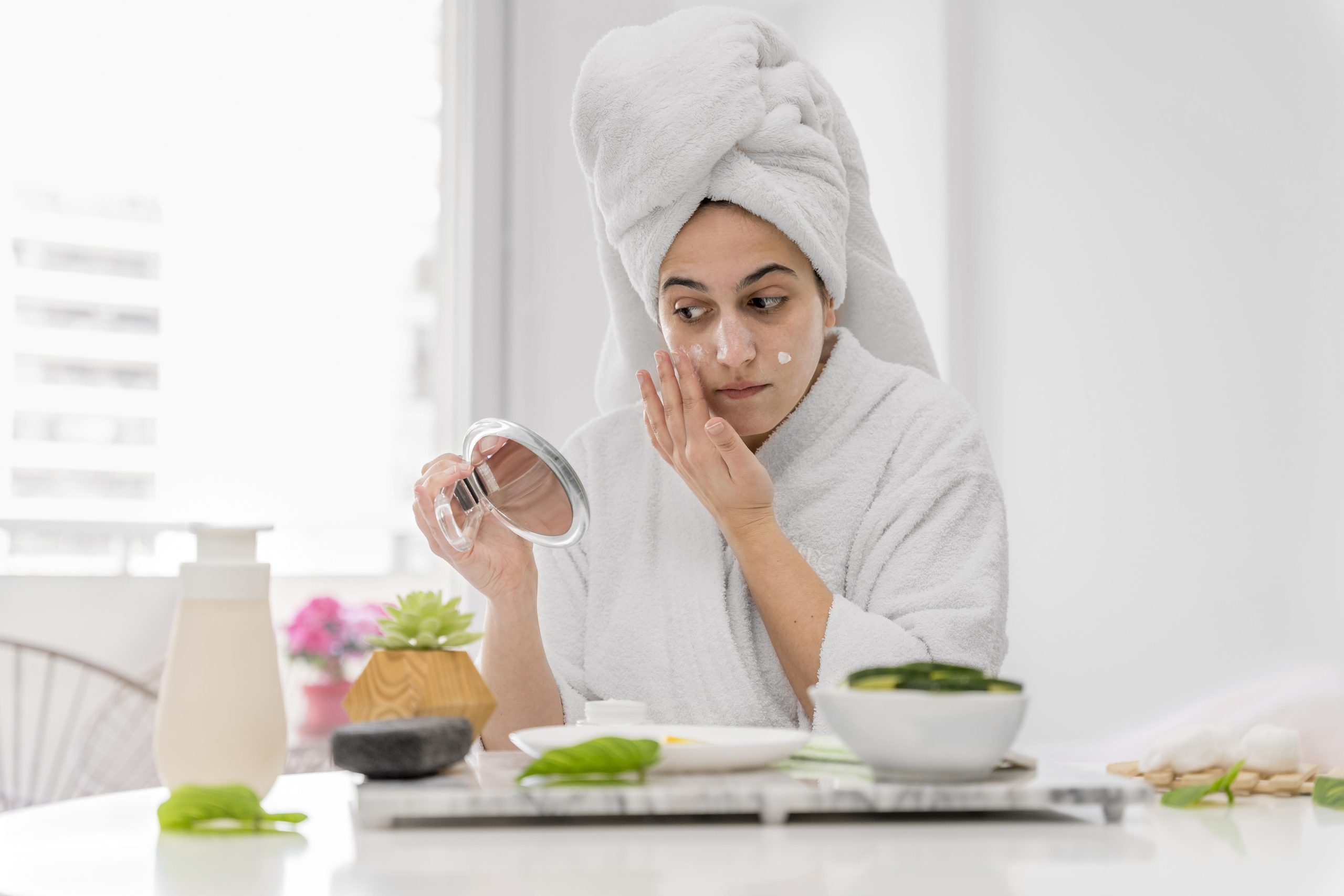 front view woman applying face cream scaled